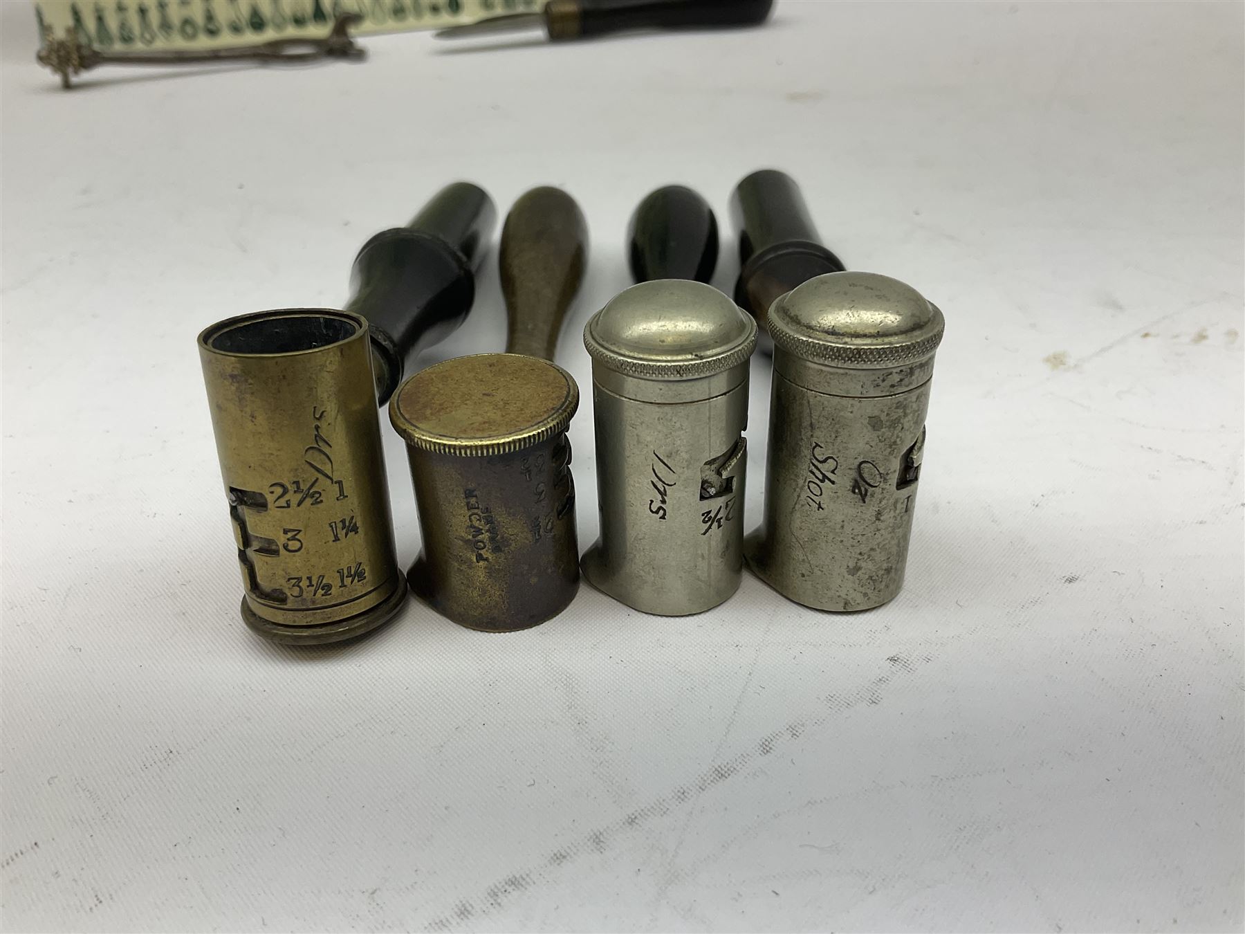 Riling Ray: The Powder Flask Book. 1992 R&R Books facsimile edition of the 1953 original; four powder measures including two by G. & J.W. Hawksley with horn handles; 16-bore combined spent cartridge and broken case remover; and turnscrew screw-driver (7)