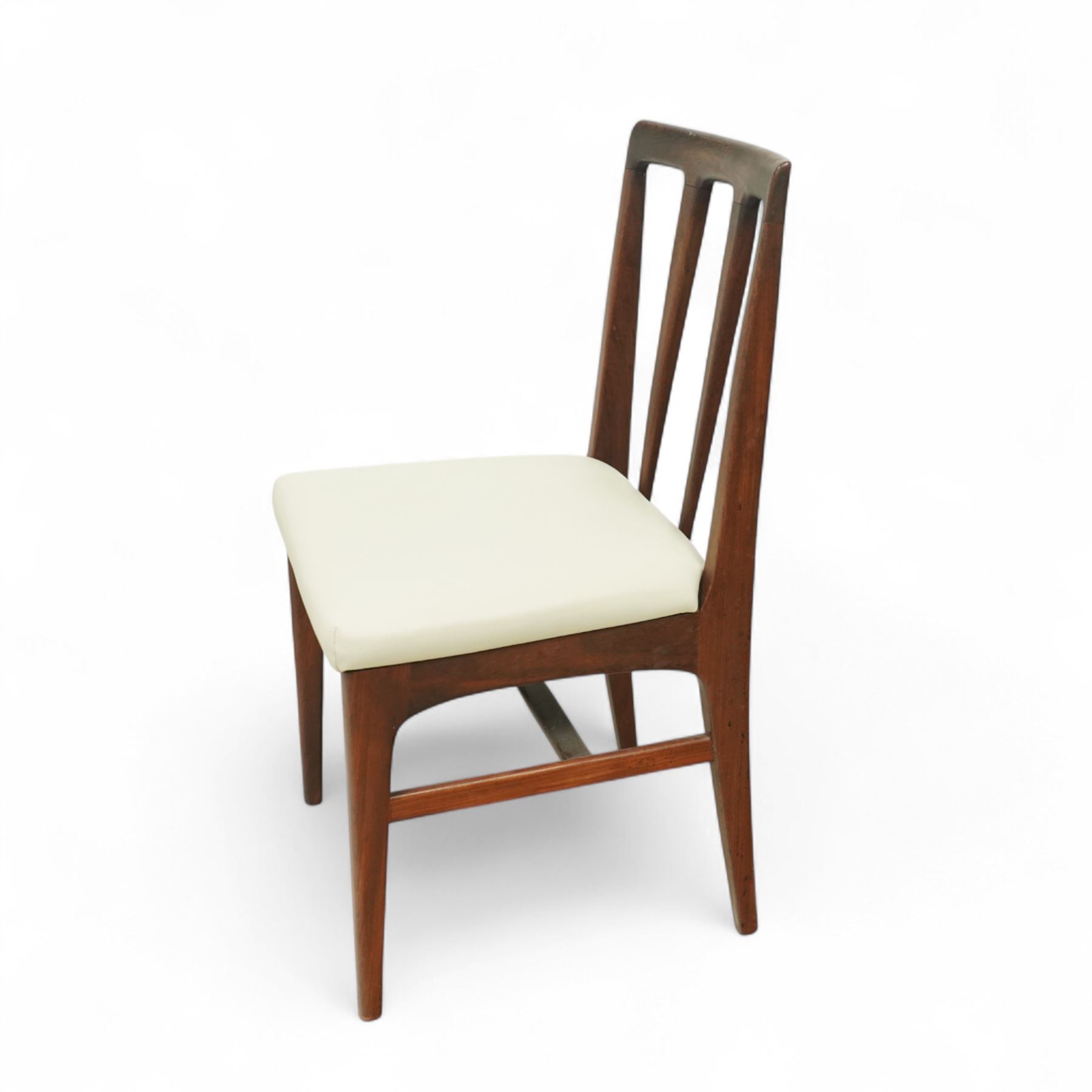 John Herbert for A. Younger  - Mid-century afrormosia teak Volnay dining table, of rectangular form with chamfered edges raised on tapering legs united by rounded stretchers, together with four afrormosia Volnay dining chairs with a gently curved top rail over triple splat open back on square tapering legs united by stretchers reupholstered in cream vinyl, chairs W50xD42xH88cm