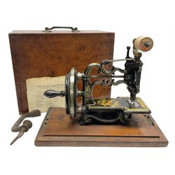 James G Weir 'The Globe' hand-cranked sewing machine, circa 1872, in black finish with gilt and flower painted decoration, the bed stamped Ja's G. Weir, 2 Carlisle Street, Soho Sq., London, with walnut locking carrying case and original manual, boxed H25cm 