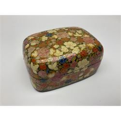 Eleven lacquered boxes including oval  and rectangular examples, with floral decoration, largest L12cm, D9cm