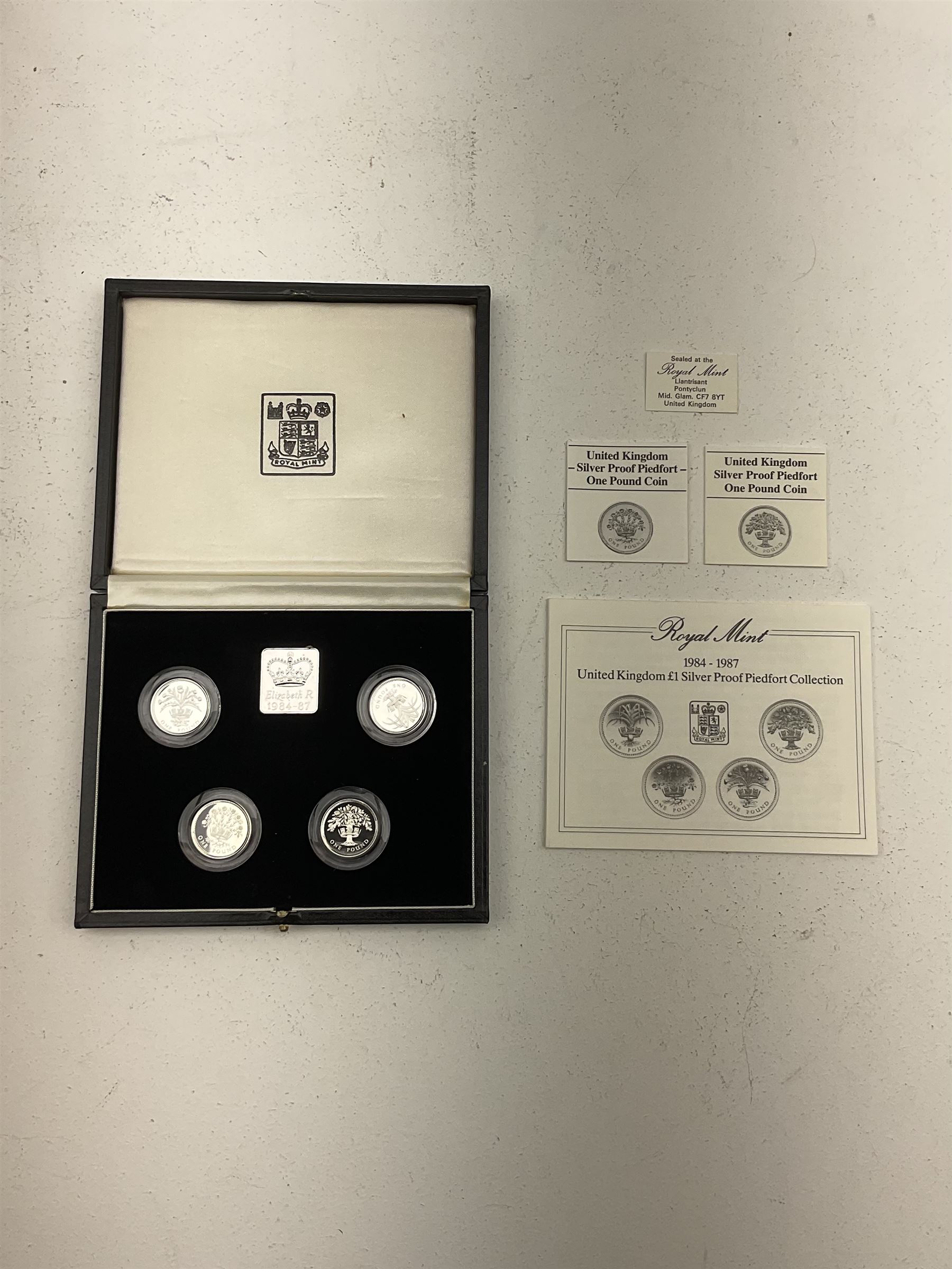 The Royal Mint United Kingdom 1984 to 1987 silver proof one pound coin collection and 1984 to 1987 silver proof piedfort  one pound coin collection, both cased with main certificate and some individual certificates 