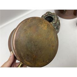 Four Victorian copper moulds, together with a graduating set of copper pans with wooden handles and finials to covers, largest pan 
