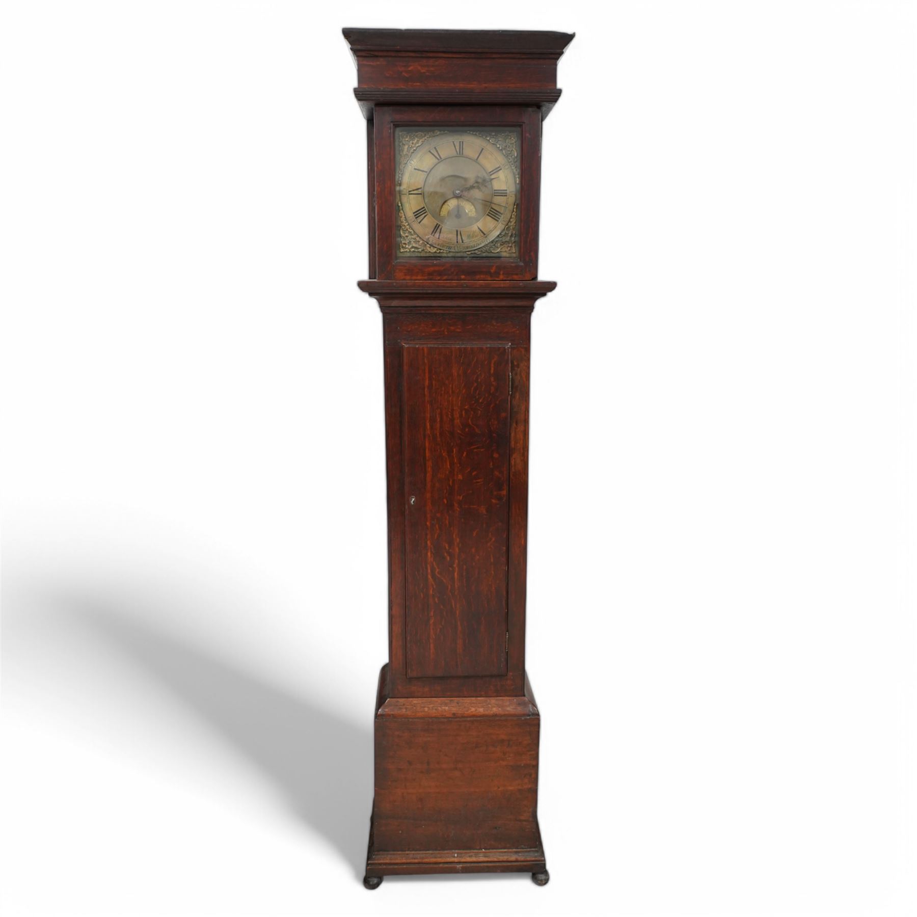 Joseph Millie of North Shields- oak cased 30hr longcase clock c1760, with a flat topped hood and deep frieze beneath, square hood door with side splats, long trunk with a conforming flat topped door with a square plinth raised on ball feet, brass dial with Rococo spandrels, matted dial centre and date aperture, chapter with Roman numerals, five minute Arabic's, minute track and matching steel hands, with a chain driven countwheel striking movement sounding the hours on a bell. With pendulum and weight.
