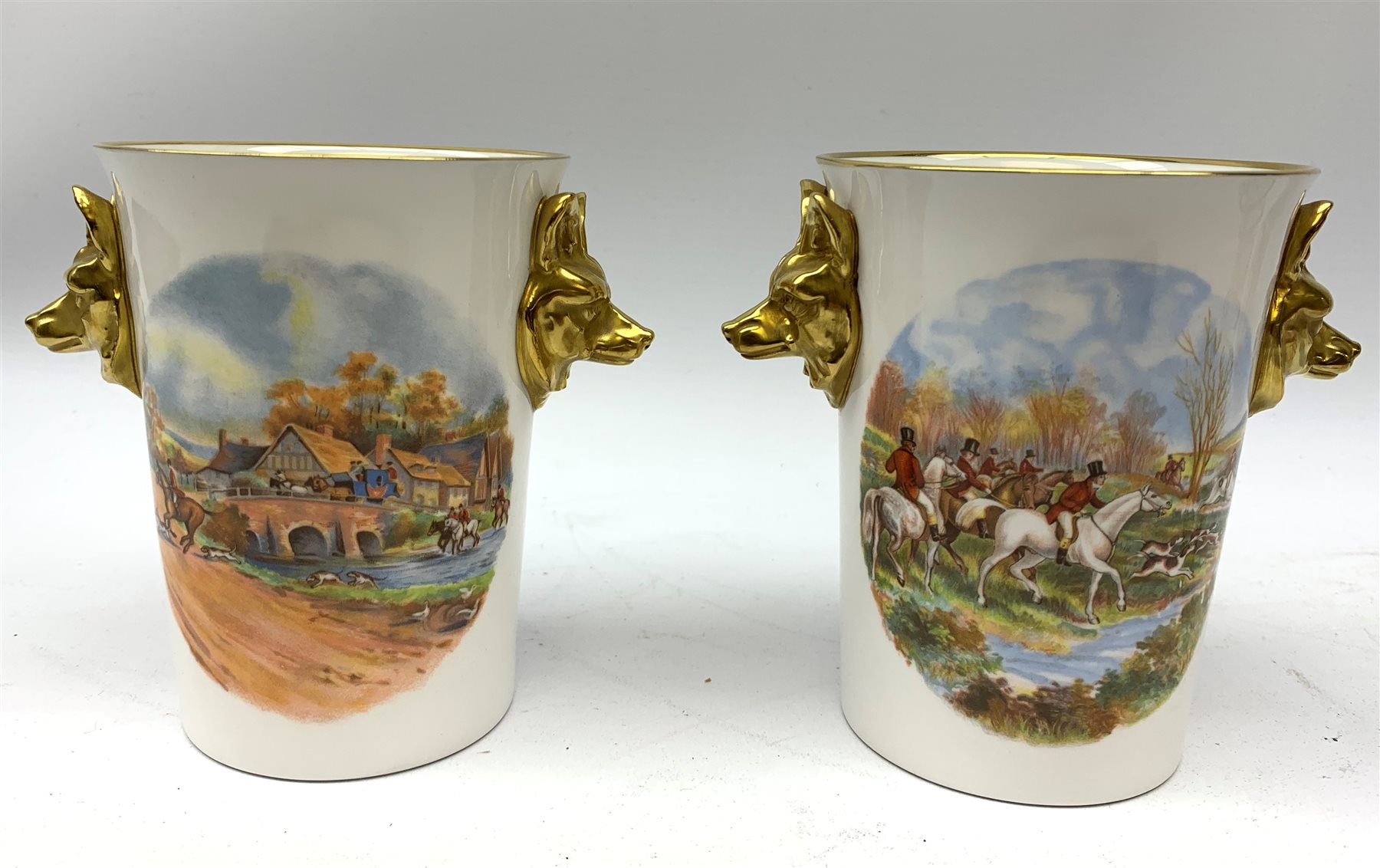  A collection of hunting related items, comprising a pair of Caverswall beakers, each with twin gilt fox head handles, H11.5cm, a limited edition Spode cabinet place depicting 'Drawing the Dingle' after J F Herring Sen, D24cm, and a set of six French shot glasses, decorated with huntsmen on horseback and hounds, H5.5cm.  