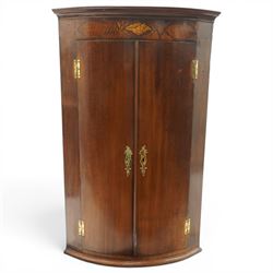 Georgian inlaid walnut cylindrical corner cupboard, projecting cornice over a banded friez...