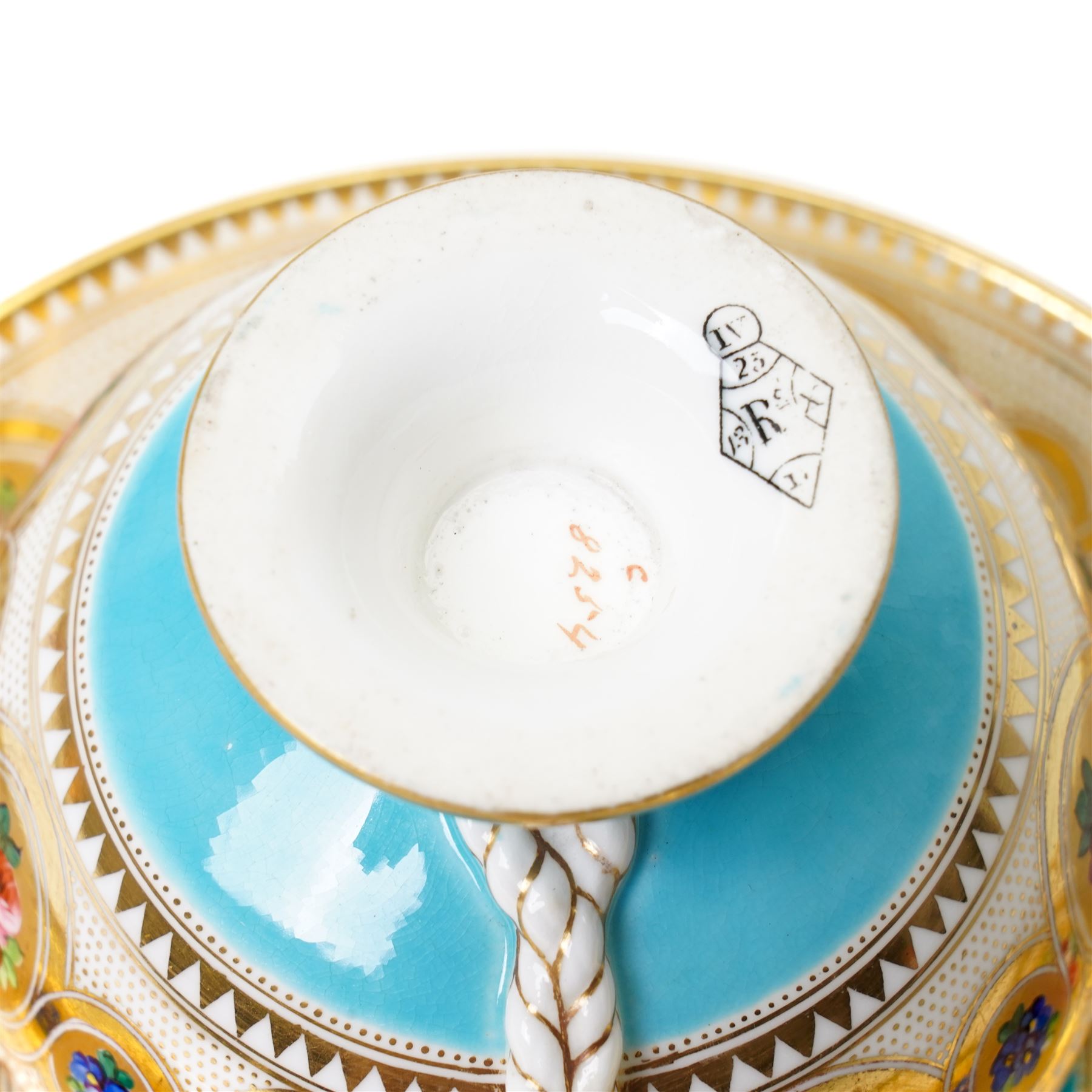 Brown-Westhead, Moore & Co cabinet cup and saucer, with rope twist moulded handle, hand-painted with floral reserves against a white and sky blue ground, heightened profusely with gilt, together with a pink hand-painted example, and a 19th century spill vase and twin-handled covered sucrier (4)