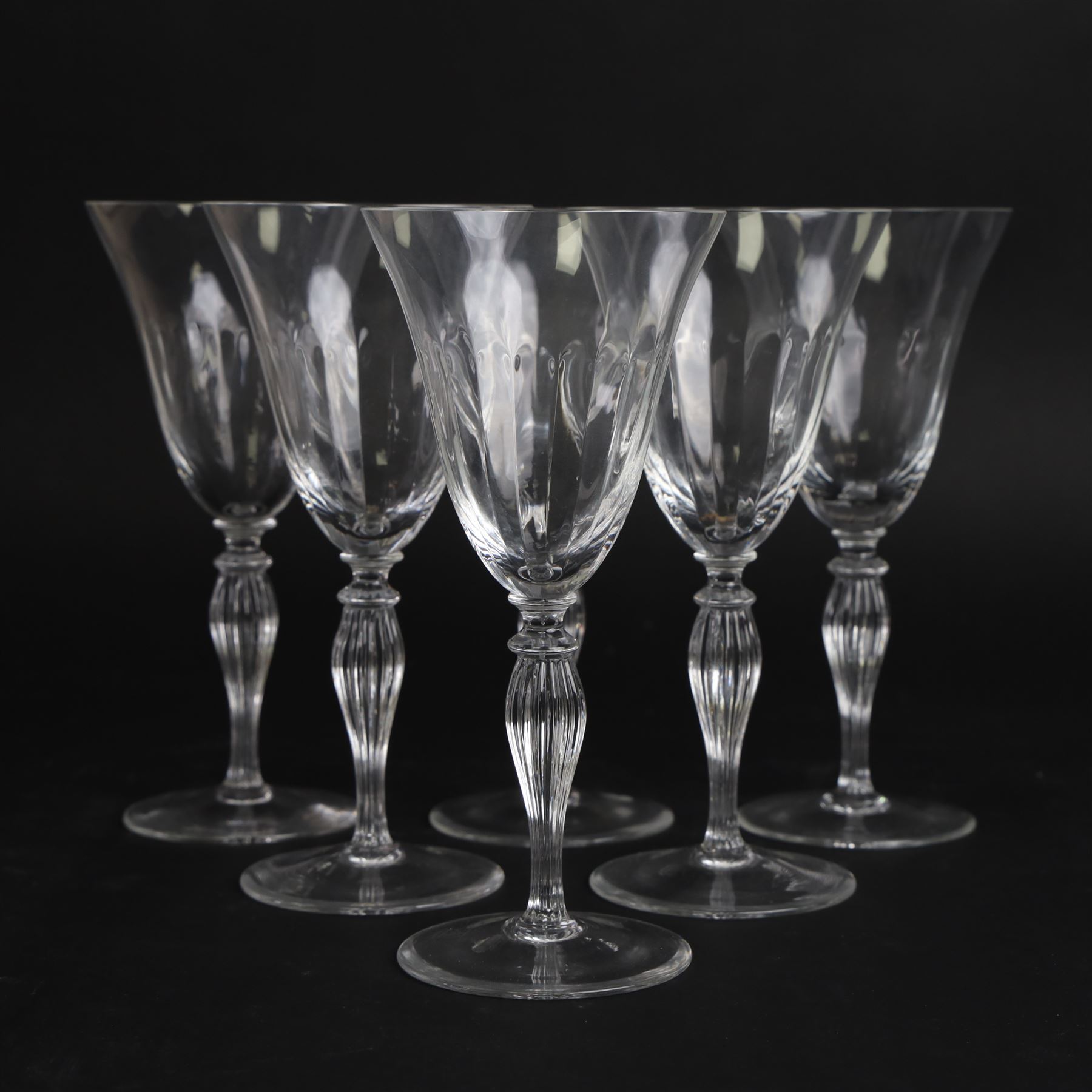 Set of six Murano clear glass wine glasses, each with part moulded fluted flared bowl, upon a knopped and fluted baluster stem and spreading circular foot, with etched marks beneath, H19.5cm