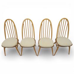 Ercol - elm dining chairs, set of six including two armchairs, arched spindle backs over shaped elm seats with upholstered pads, tapering beech legs joined by stretchers