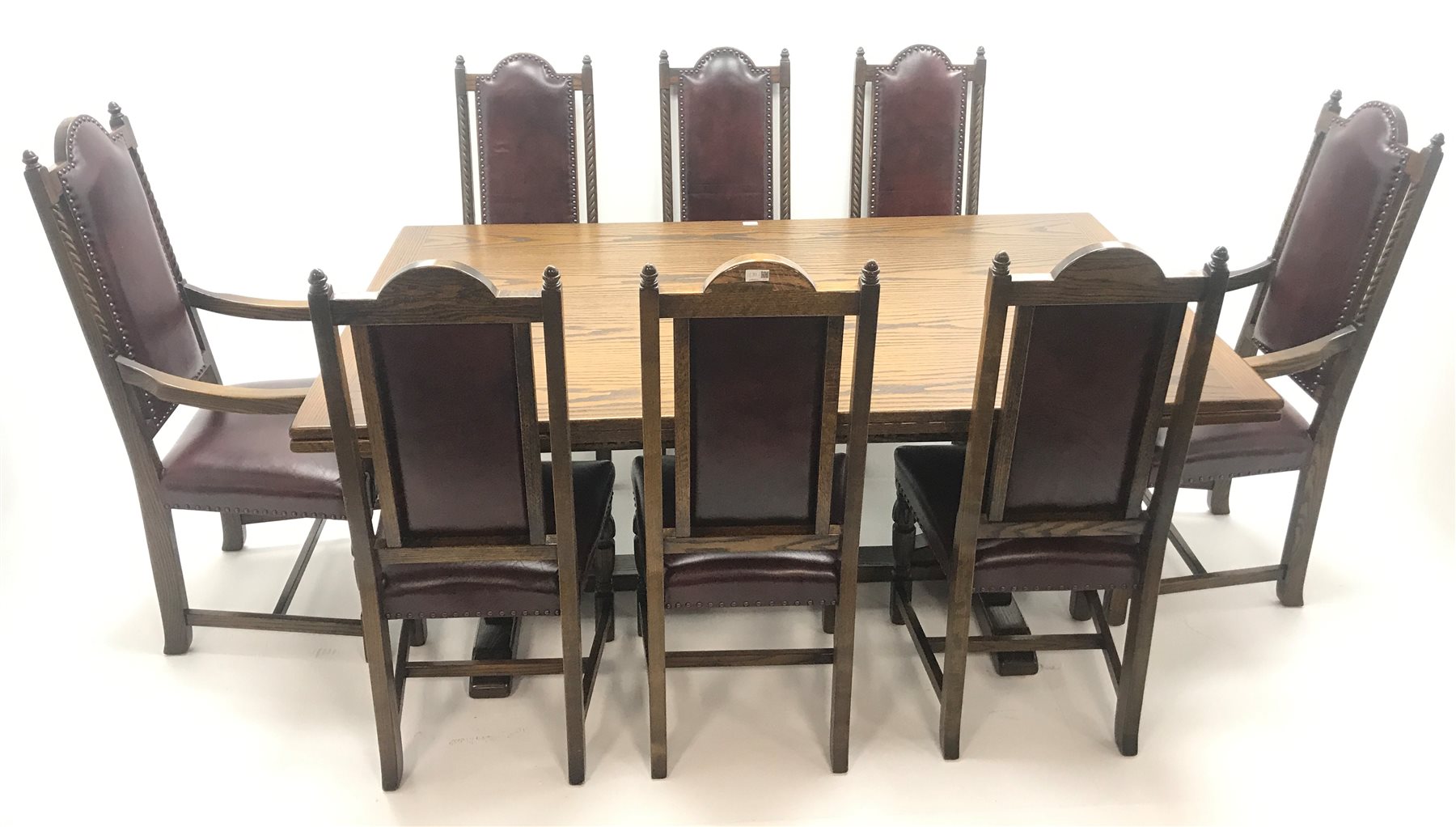  Old Charm oak drawer leaf dining table, carved cup and cover supports on shaped sledge feet joined by single stretcher (W275cm extended, 183cm closed, H76cm, D108cm) and set eight (6+2)  chairs, arched cresting rail with finials, studded leather back and seat, cup and cover supports joined by stretchers (W  