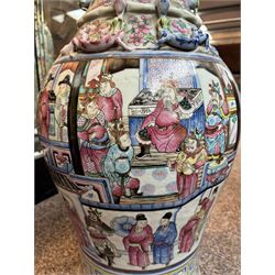 Large pair of 19th century Cantonese famille rose vases, each painted with various courtly scenes, including a display of warriors fighting on horseback before an official and his attendants, double Buddhist lion handles and applied at the shoulders with chilong, the lower band painted with Greek key motif, H58cm (2)