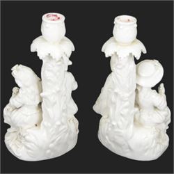 Pair of 19th century Meissen style Blanc de Chine figural candlesticks, each depicting children gathering flowers, with spurious mark beneath, H21cm