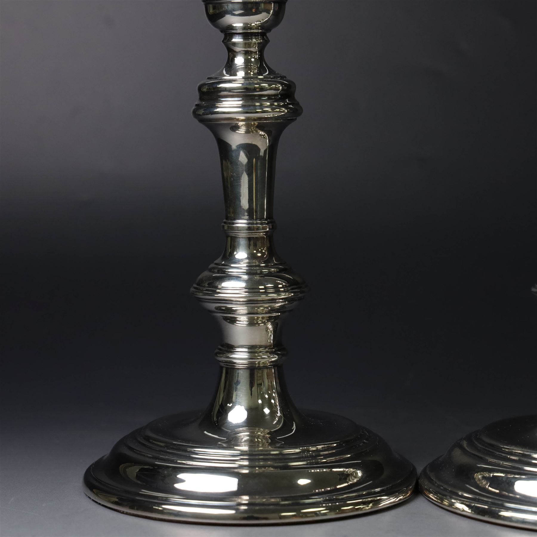 Pair of silver candlesticks, with knopped stems and upon spreading circular weighted bases, hallmarked William Comyns & Sons Ltd, London 1979, H20cm