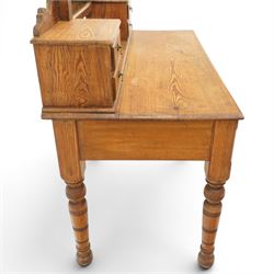 Victorian stripped pine dressing table, rectangular top over two drawers with brass handles, the raised back fitted with adjustable rectangular mirror, spindle gallery flanked by two short jewellery drawers either side, on turned legs