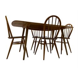 Ercol - model 382 light elm and beech dining table, rectangular plank top raised on tapering supports (W150cm D75cm H72cm); with set of four hoop and spindle back chairs