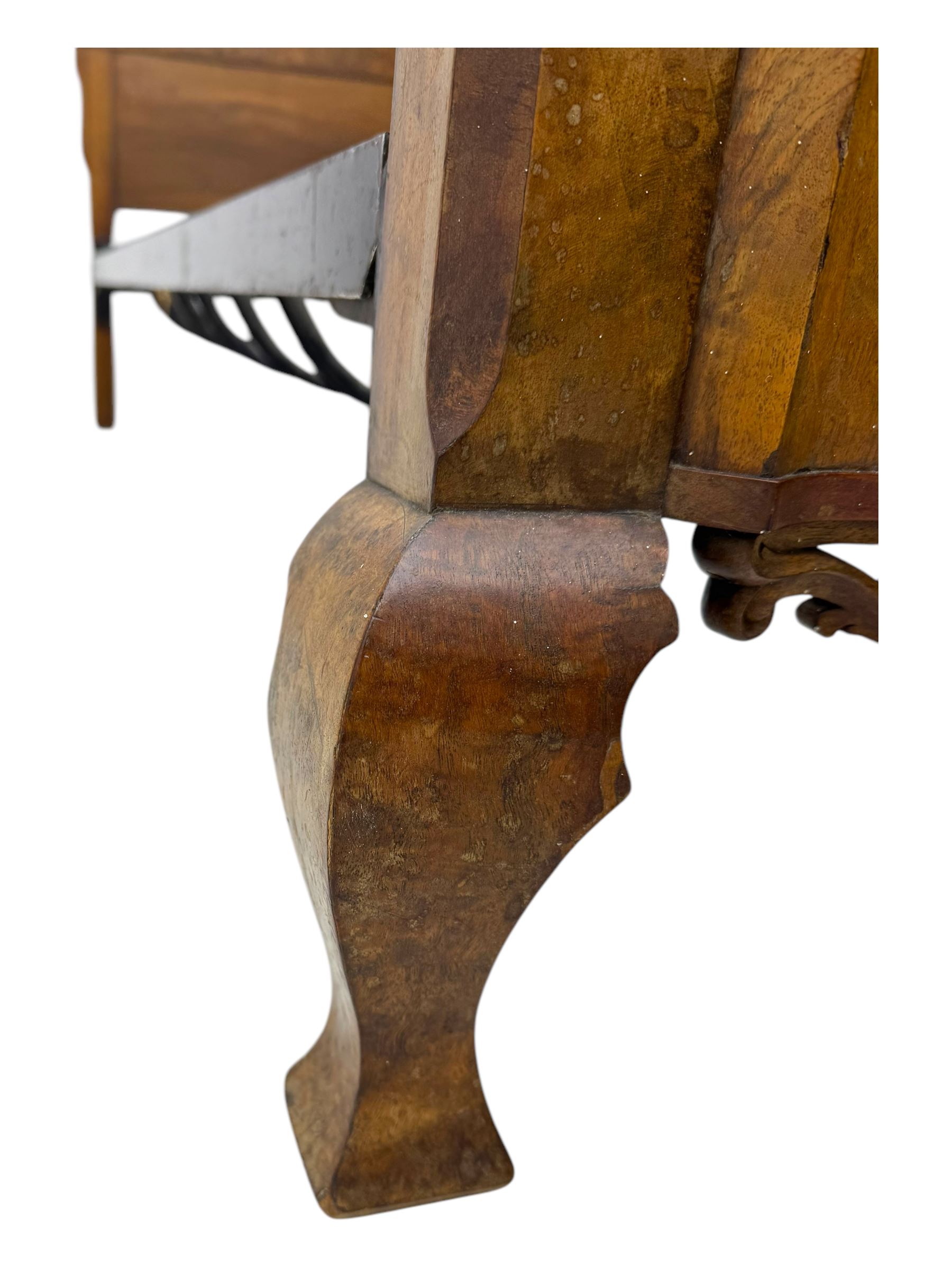 Mid-20th century walnut single bedstead, high shaped headboard, footboard with turned finials and scrollwork carvings, complete with 'Vono' iron frame, raised on cabriole supports