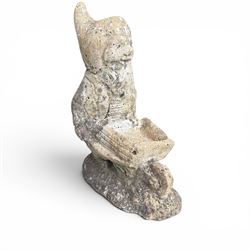 Two seated cast stone garden gnomes