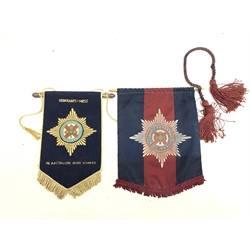  A framed Irish Guards music stand banner with woven badge 61cm x 59cm, an Irish Guards Sergeants Mess pennant with woven badge by Mayfield Jays H25cm and another with printed badge (3)  