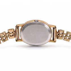 Omega ladies gold-plated quartz wristwatch, gilt dial with baton hour markers, on 9ct gold bracelet, Birmingham 1977, boxed with original leather strap