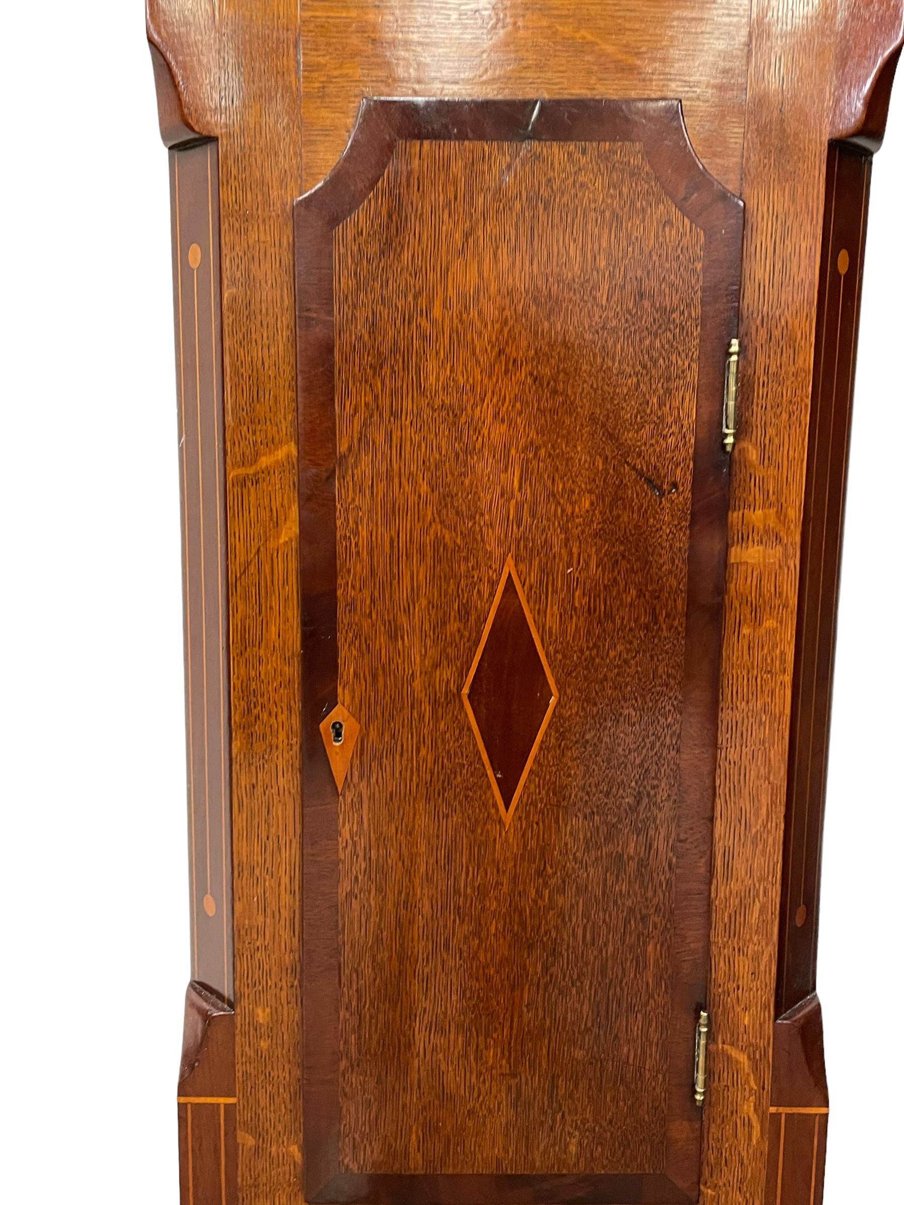 Musson of Louth - mid-19th century oak and mahogany 8-day longcase clock, with a swan’s neck pediment and ball and spire brass finial, break arch hood door flanked by reeded pilasters with brass capitals, canted angled trunk, flat topped door with concave corners, rectangular plinth on bracket feet, fully painted break arch dial with Roman numerals and minute track, subsidiary seconds dial and calendar aperture, matching stamped brass hands, eight day rack striking movement with anchor escapement. With weights and pendulum.
H206 W44 D23
Balthazar Musson from Baden (Germany) is recorded as working in Louth from 1835, naturalised 1861-8. Succeeded by his son, George Balthazar 1872-1920. 
