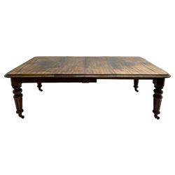 19th century mahogany extending dining table, moulded rectangular top with rounded corners, telescopic winding action, turned and fluted supports on brass castors, two additional leaves