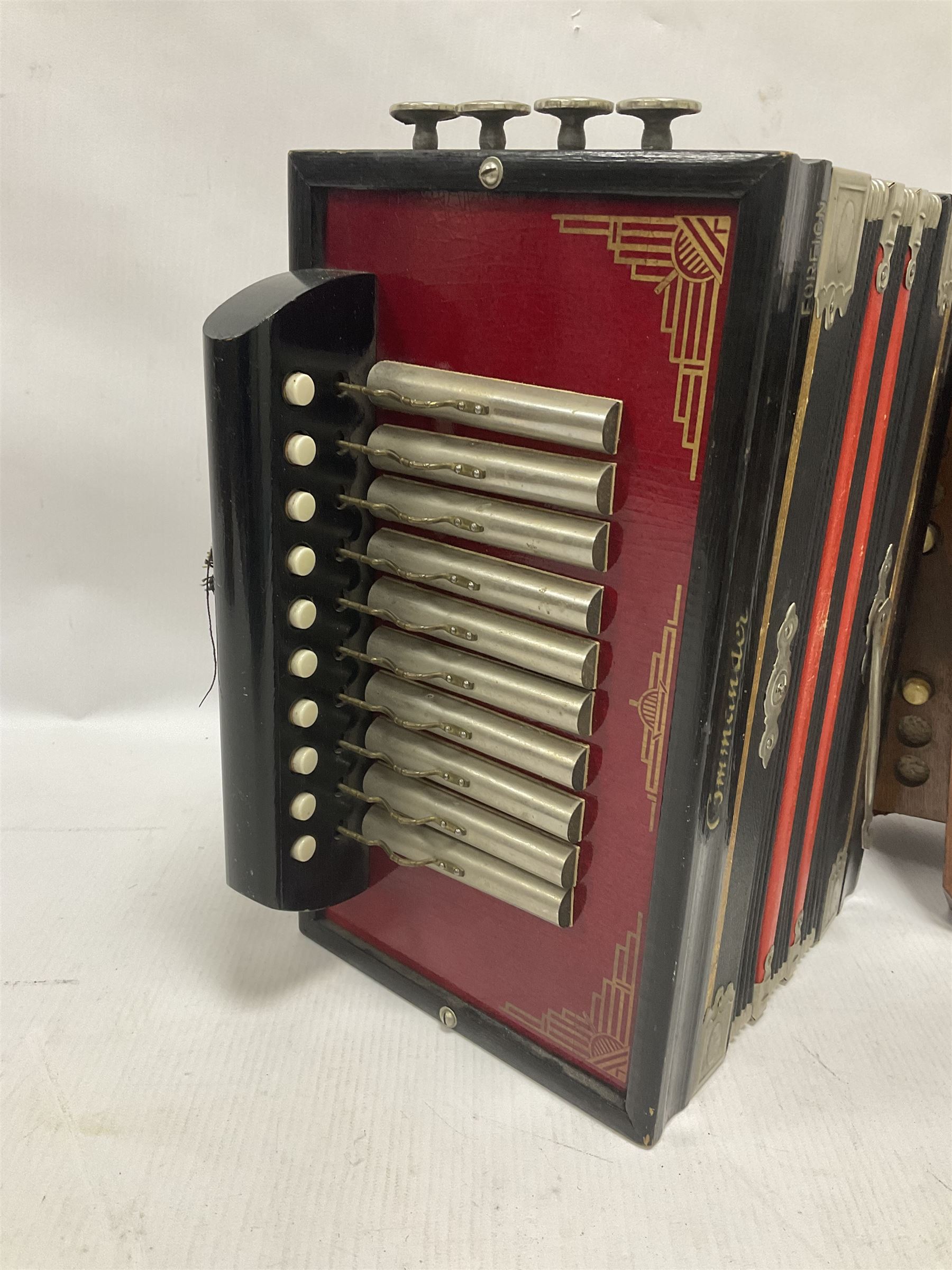 Three European concertinas, comprising Viceroy German concertina with 21 keys, hexagon wooden frame and 8 fold bellows
Oak framed concertina with 12 keys and 8 fold bellows
Commander concertina with 12 keys and 12 fold bellows
With tutor