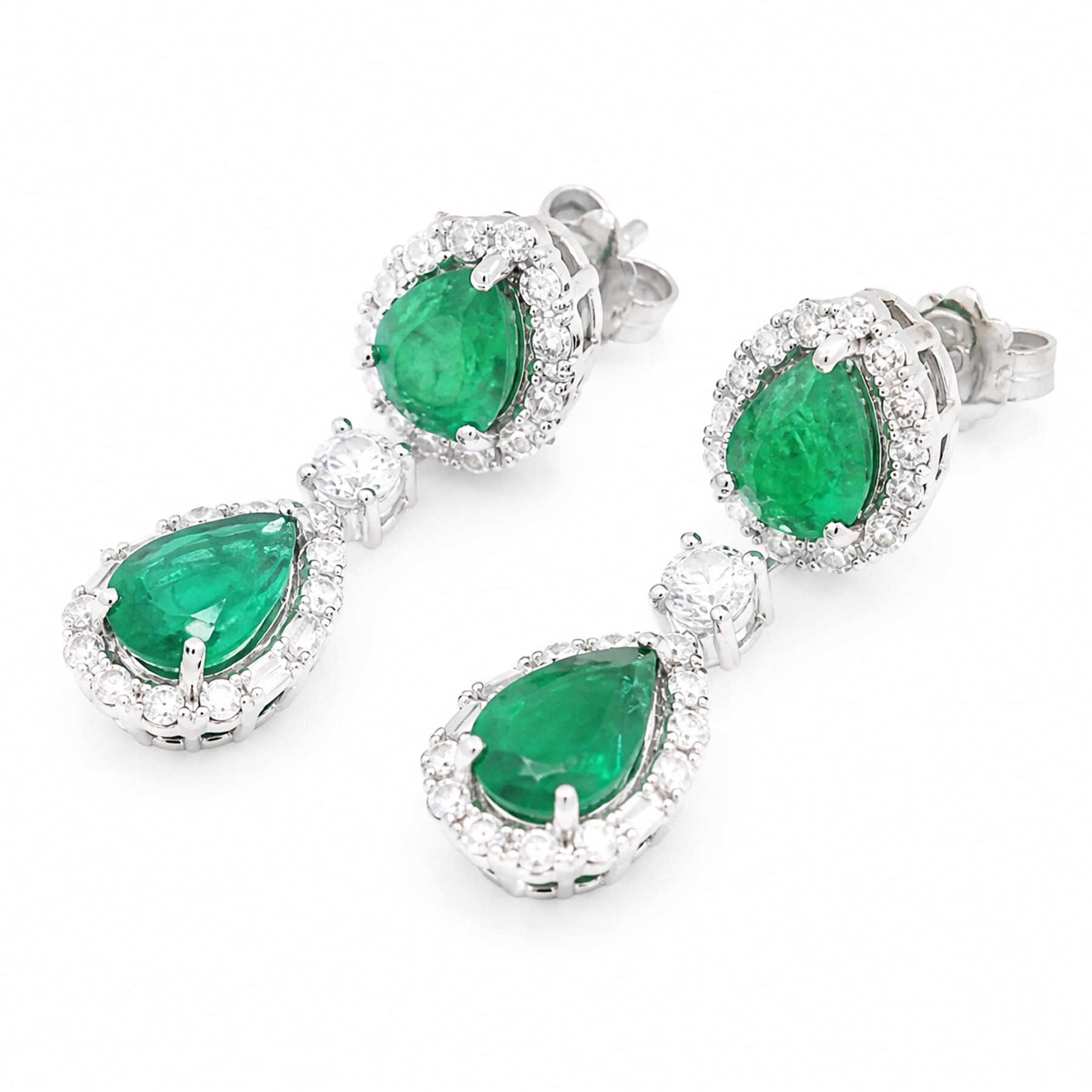 Pair of 18ct white gold emerald and diamond earrings, each stud set with two pear cut emeralds, surrounded by round brilliant cut and baguette cut diamonds, spaced by a single diamond, stamped, total emerald weight approx 4.15 carat, total diamond weight approx 1.50 carat