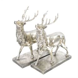 Pair of composite silvered stags, on rectangular base H37cm