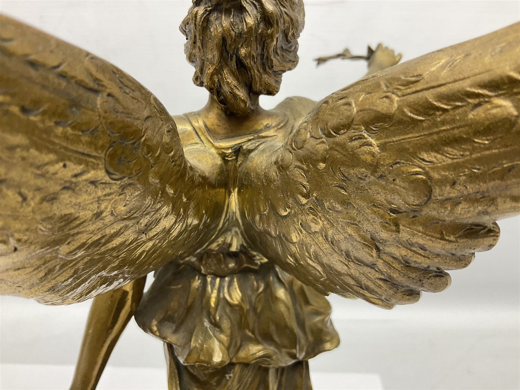 After Oswald Schimmelpfennig (German, 1872-1939): Pair of gilt bronze winged Allegorical female figures, the first example with arm outstretched holding a branch, signed 'Schimmelpfennig 1900', the second with arm raised above her head holding a book and sword in the other, both raised upon marble plinths, H45cm