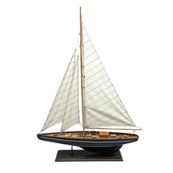 Wooden built model yacht with linen sails and mounted on wooden base, H86cm