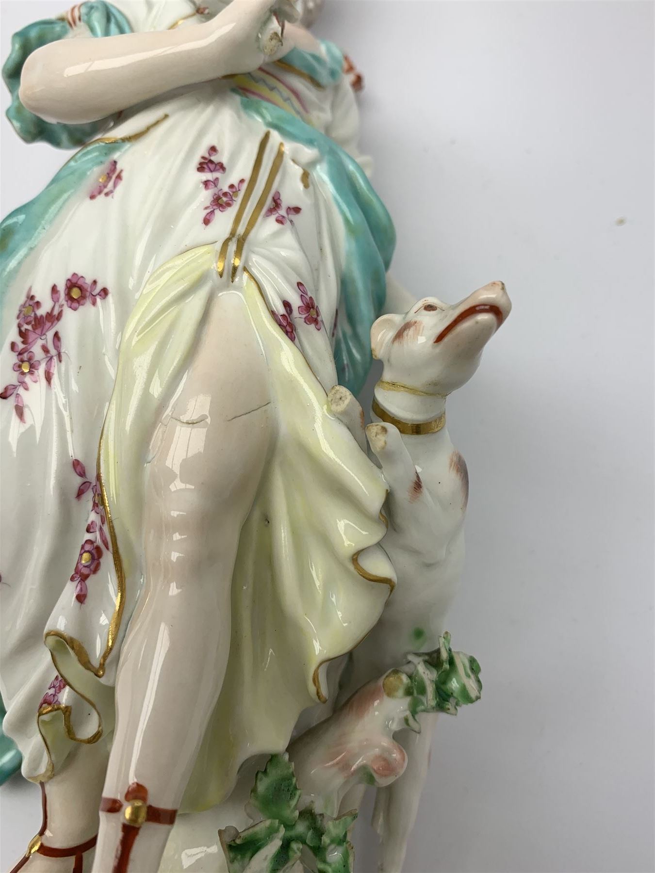 Mid 18th century Derby porcelain figure modelled as Dianna the Huntress, with quiver of arrows upon her back and dog by her side, upon a naturalistically modelled base, with patch marks beneath and collectors labels, H26cm