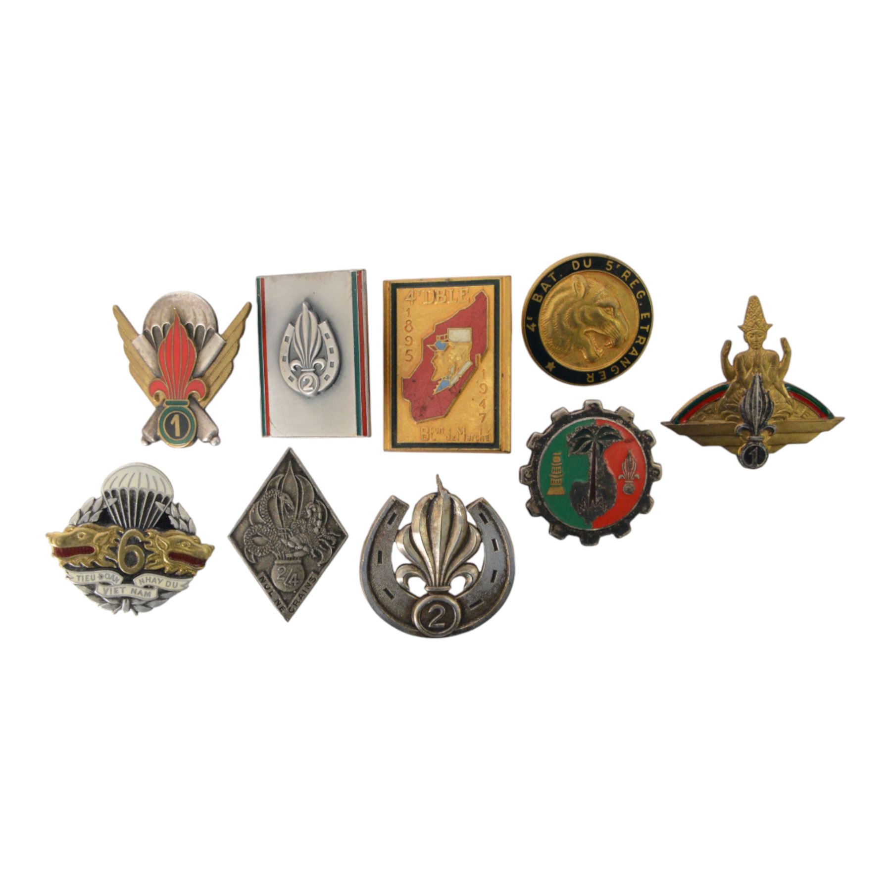 French Foreign Legion etrangere badges comprising seven  Kepi Blance Replacements and two Legion Cavalerie badges
