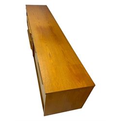 Mid-20th century teak sideboard, fitted with a fall-front cupboard, three drawers including a green baize-lined cutlery drawer, and a double cupboard, with integrated handles, on sleigh supports