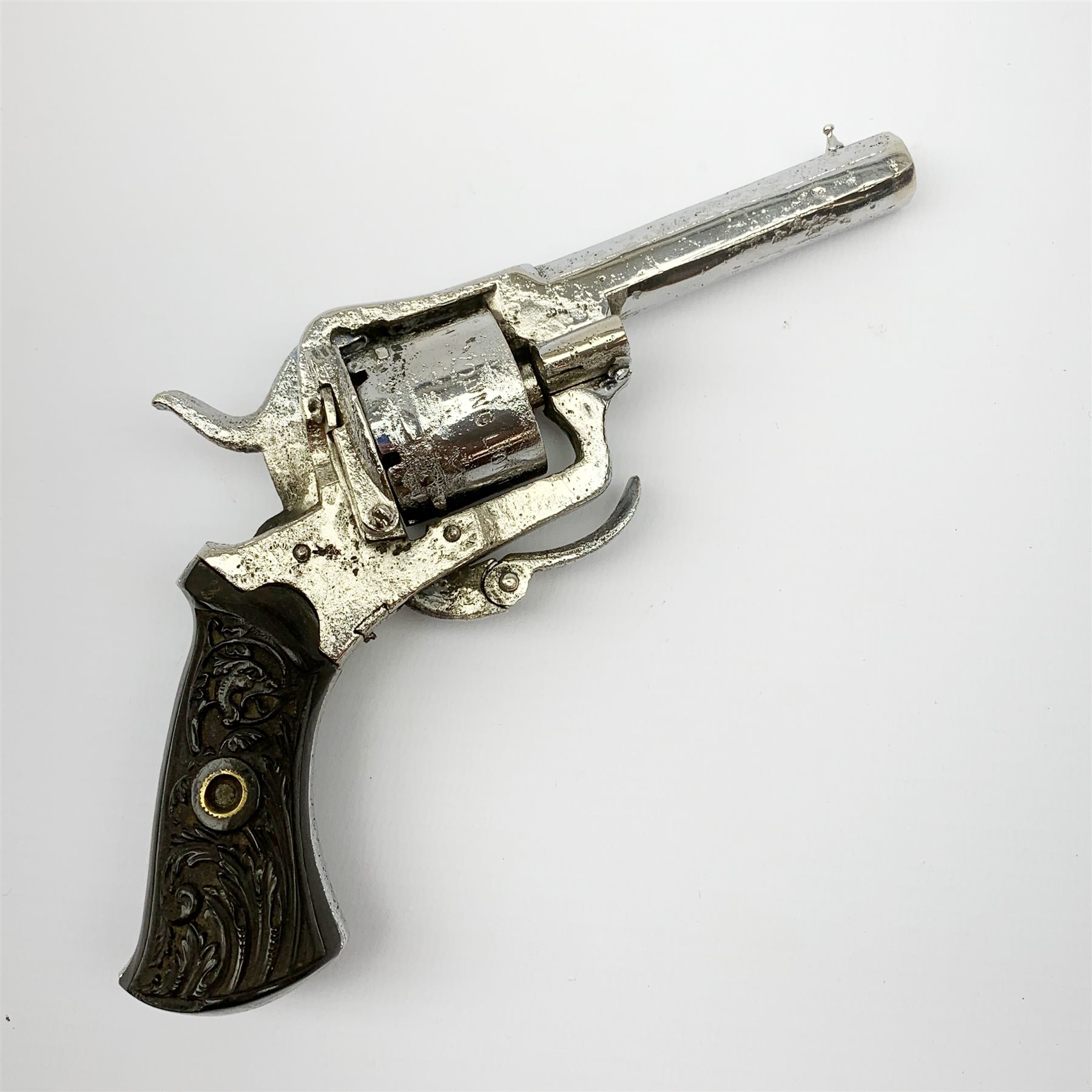 19th century plated Belgian 7mm pin-fire revolver, the six-shot cylinder inscribed 'The Young Lion 1881 New Pattern', with folding trigger and carved walnut split stock, barrel length 7.5cm, overall length 18.5cm