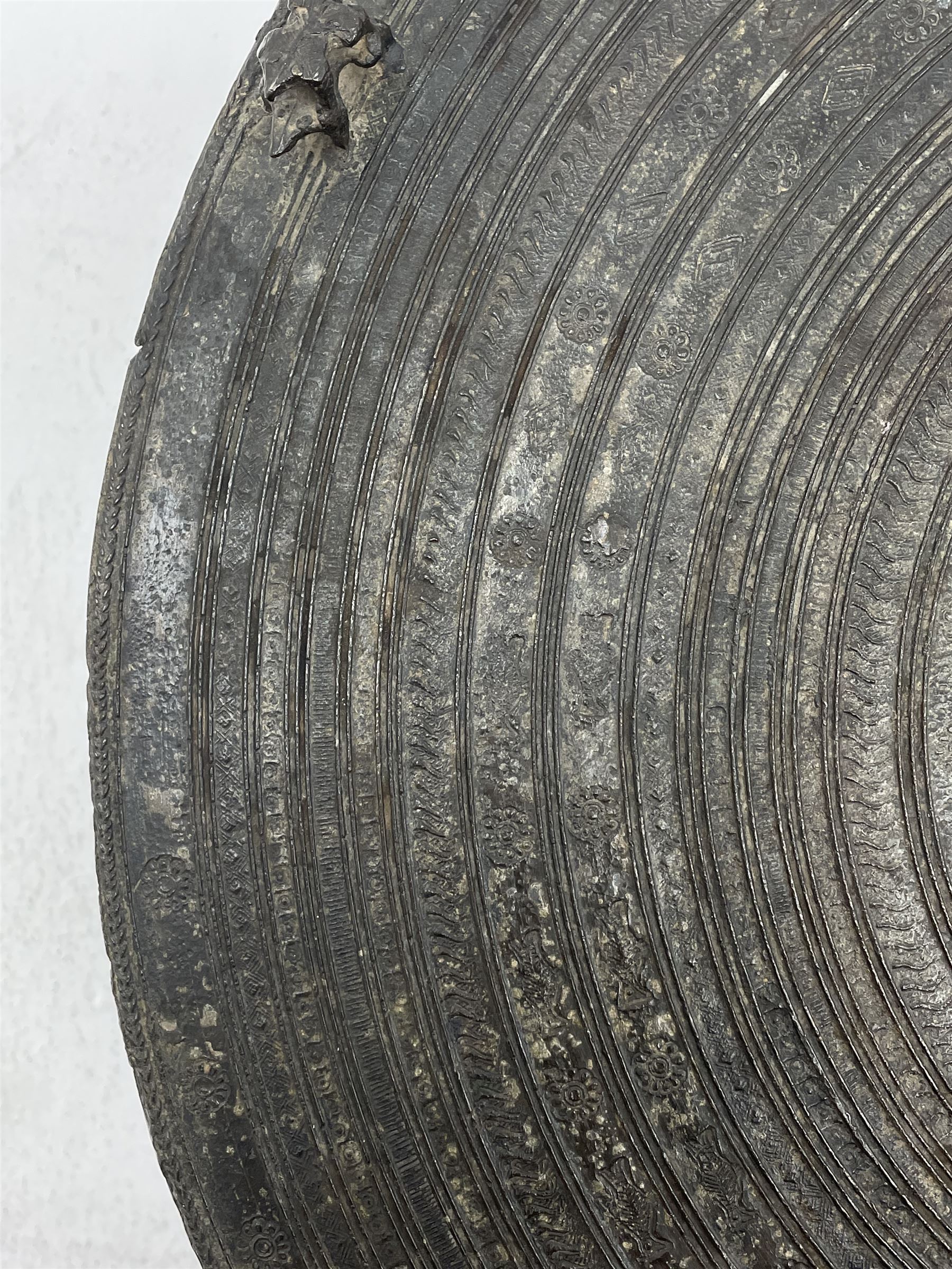 Dong Son style Southeast Asian bronze rain drum, the top decorated with concentric bands with stylised motifs and geometric shapes, central twelve point star, the tapered body with loop handles, set with small elephant and animal figures