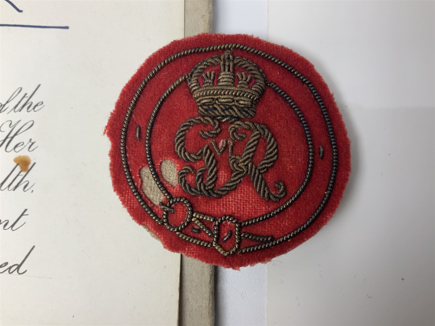 George VI Knight of the Garter cloth beret insignia with pin back and photograph of the Knight's Robes; Edmund Fellowes book on The Knights of the Garter 1348-1939; together with EIIR civilian OBE certificate to Jeffery Stanford Agate with facsimile signatures of Elizabeth II and Prince Philip