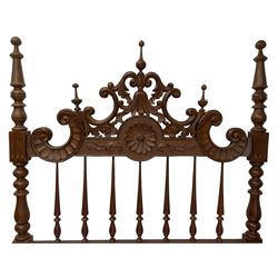 Pair of Spanish carved hardwood headboards, the pediment carved and pierced with shell C-scrolls and carved foliage, turned spindle back, on turned supports 