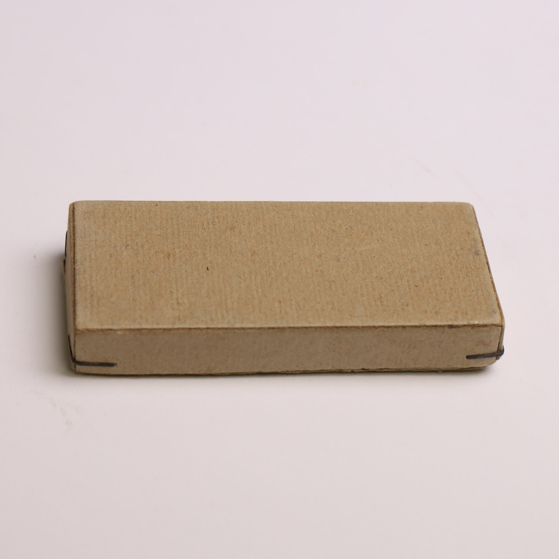 WWII German Kriegsmarine U-Boat combat clasp in bronze by Schwerin Berlin, with the original horizontal pin and catch fixing, makers mark to the reverse “ENTWURF PEEKHAUS AUSF SCHWERIN BERLIN 68” in original packaging
