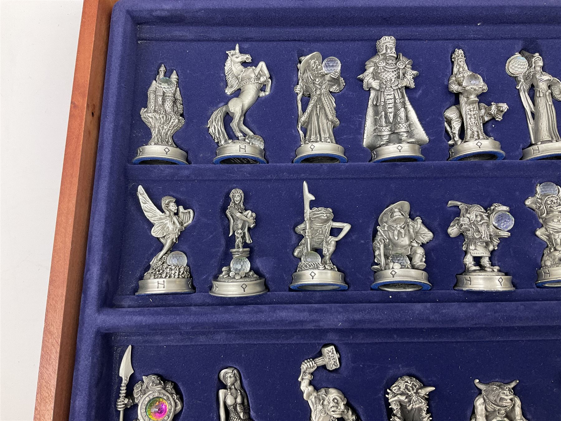 Danbury Mint 'The Fantasy of the Crystal' chess set consisting of mythical pewter chess pieces within a wooden case with chess board lid, together with 16 additional chess pieces in a wooden display case.