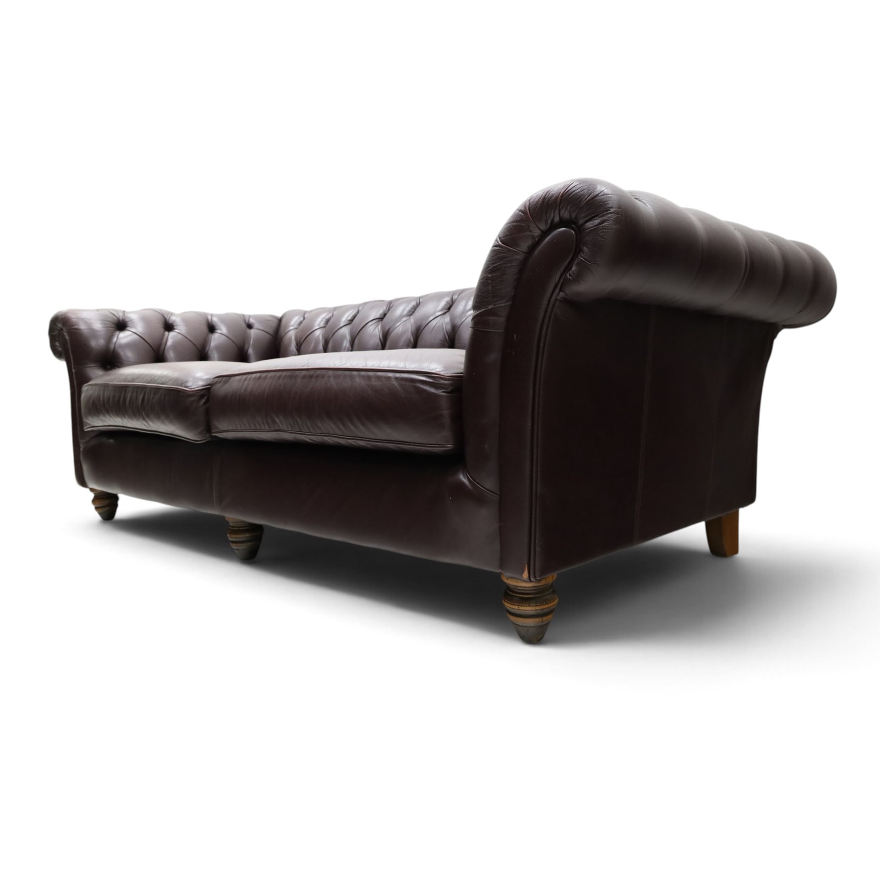 Thomas Lloyd - traditional shape Chesterfield two seater settee with rolled back and arms, upholstered in buttoned deep oxblood leather with loose seat cushions, raised on turned feet