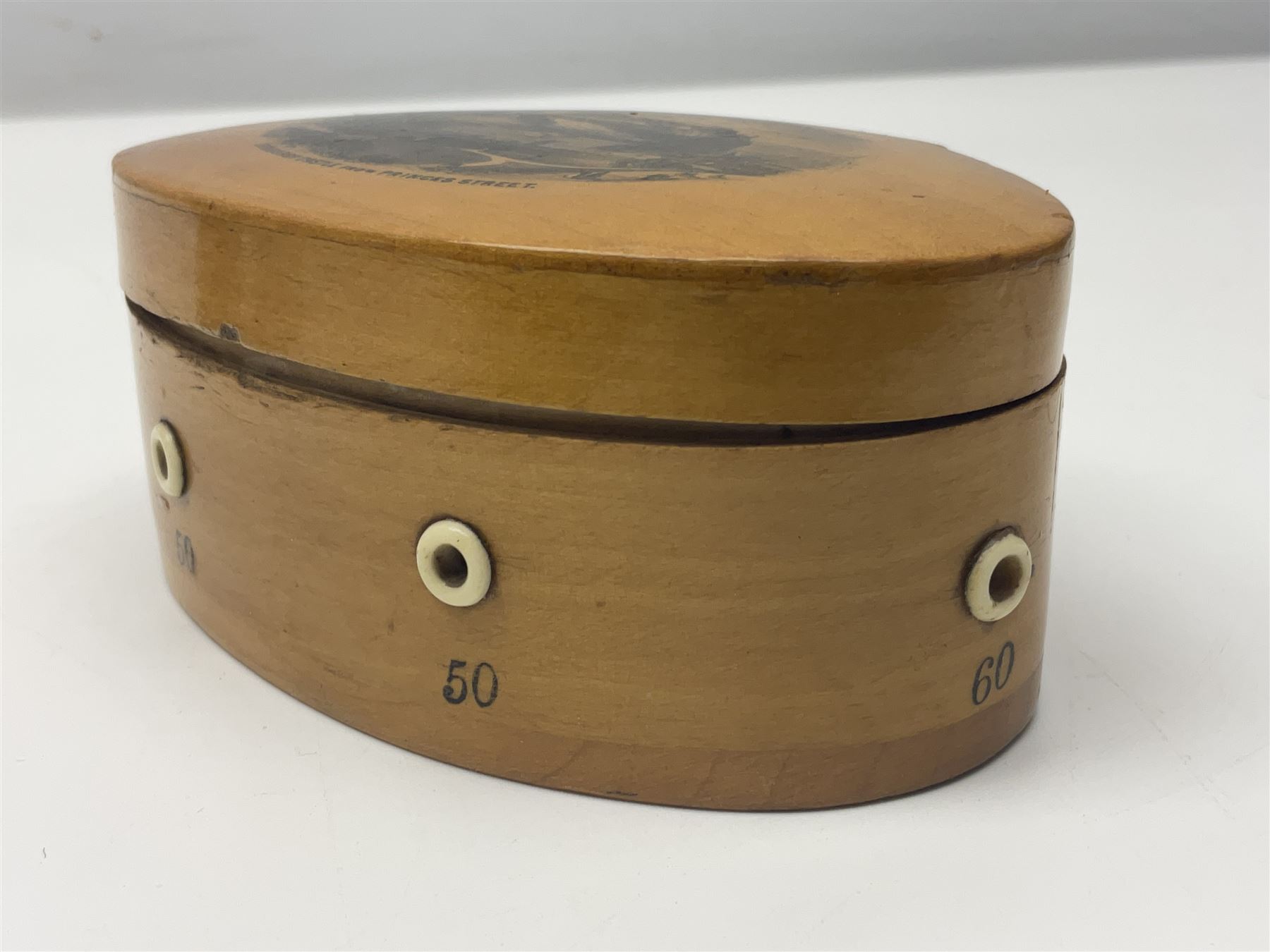 Six sewing related Mauchline ware comprising an oval reel box with internal label for Clark & Co's, tape measure, pin case and three thimble holders of ovoid form 