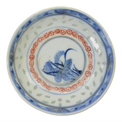 Chinese late Qing Dynasty Guangxu period rice grain detailed teabowl and saucer, each decorated in underglaze blue with flowers and foliate borders, and further detailed with iron red and pale green band of flower heads, and scrolling bands, teabowl with apocryphal Kangxi mark beneath and saucer with apocryphal Qianlong mark beneath, teabowl H5cm, saucer D10cm