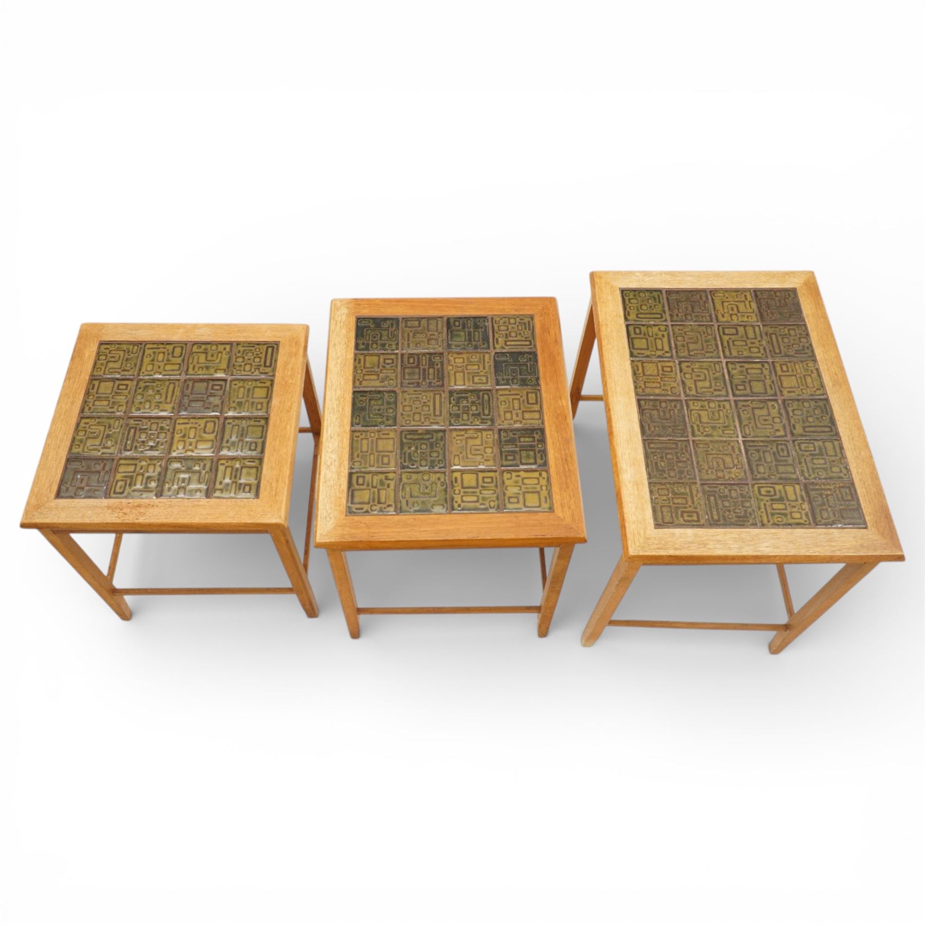 Mid 20th century Danish teak nest of three tables, rectangular tops inset with green geometric ceramic tiles within moulded frames, on square tapering supports united by stretchers