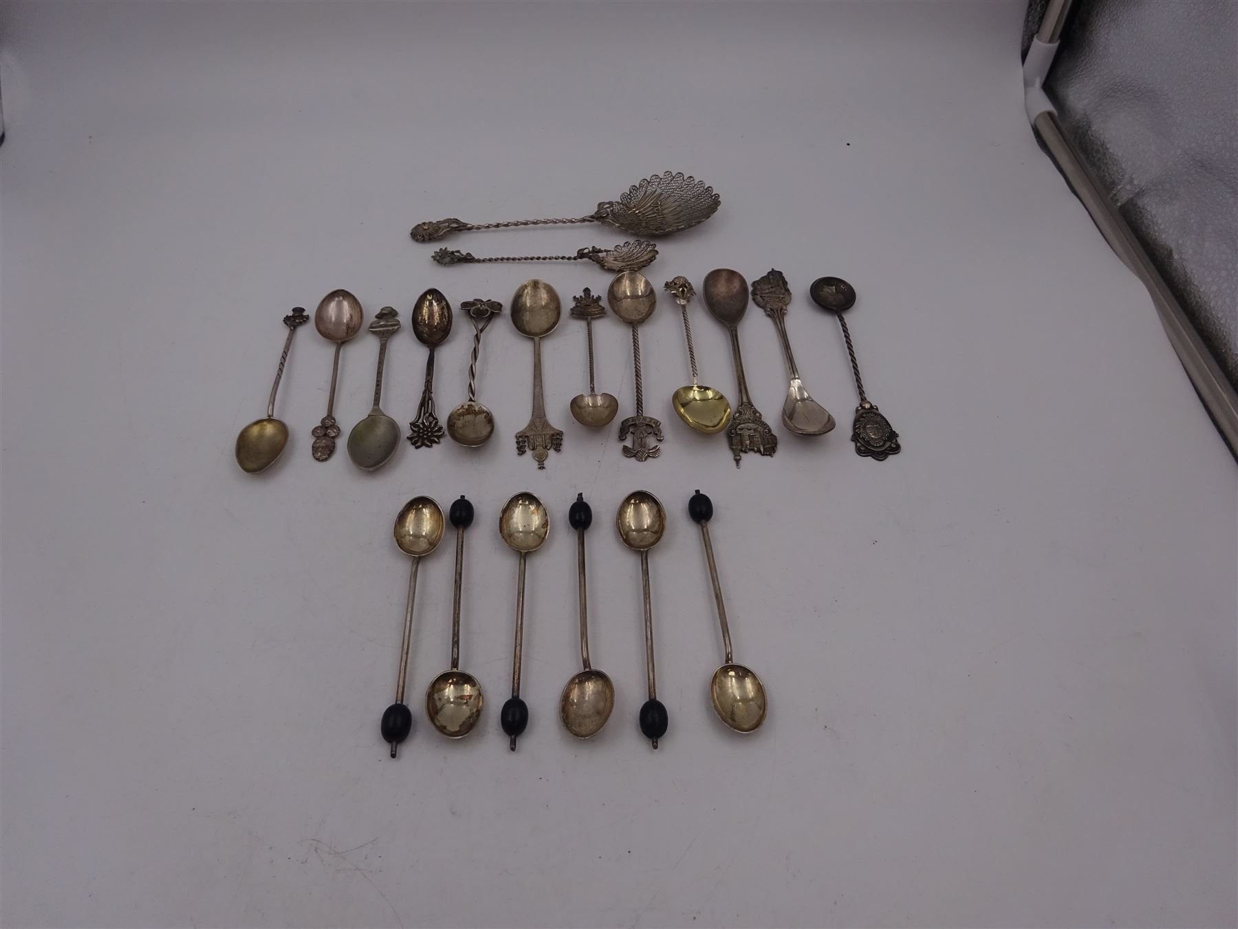 Set of six 1920s silver coffee bean spoons, together with a collection of silver souvenir and similar spoons, including two filigree examples, all tested or hallmarked