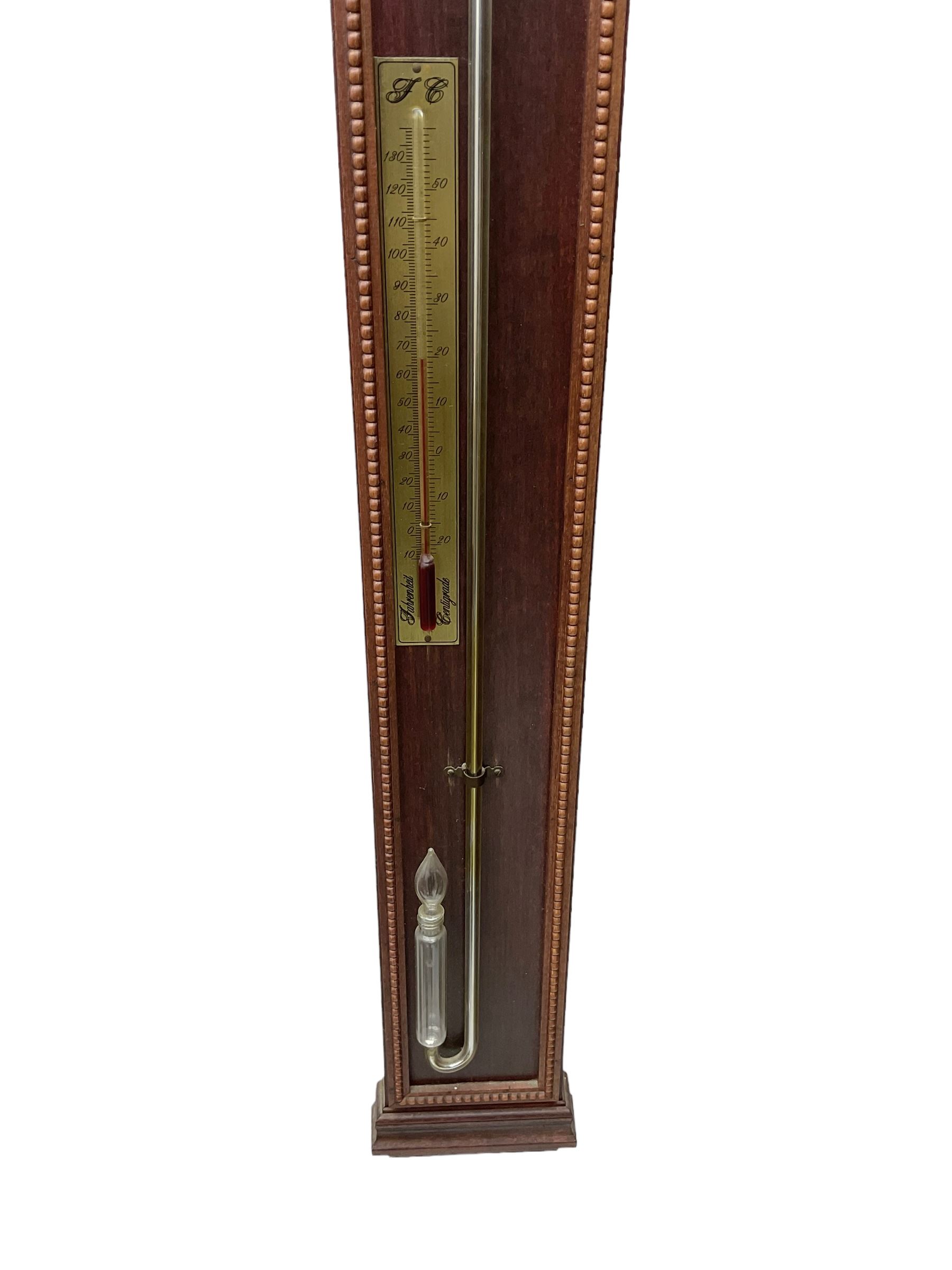 20th century - Replica mercury wall mounted stick barometer, fully glazed case with a gilt register measuring air pressure in inches, adjustable vernier and recording pointer, with a conforming thermometer  recording the temperature in degrees Fahrenheit and Celsius.  