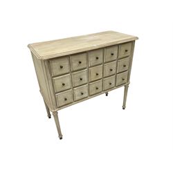 Washed finish pigeon hole or apothecary style chest, fitted with fifteen drawers, raised on fluted tapered supports 
