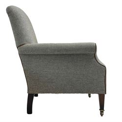 Interiors at Nine to Eleven - Edwardian design armchair, traditional shape with rolled arms, upholstered in 'Harris Tweed' fabric with leather piping, raised on square taping supports with castors