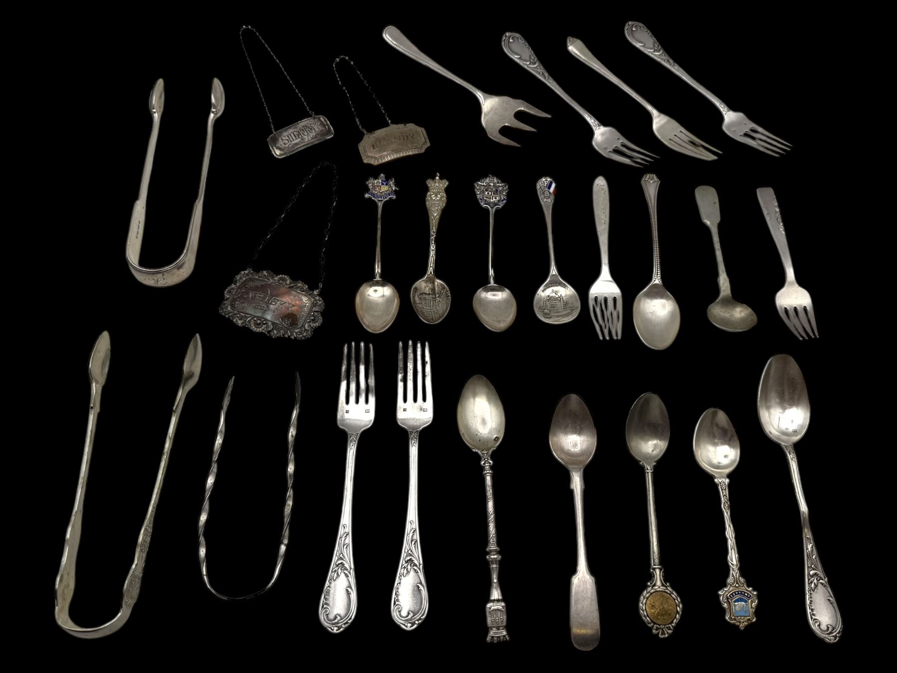 Three silver decanter labels and a collection of silver and silver plated cutlery