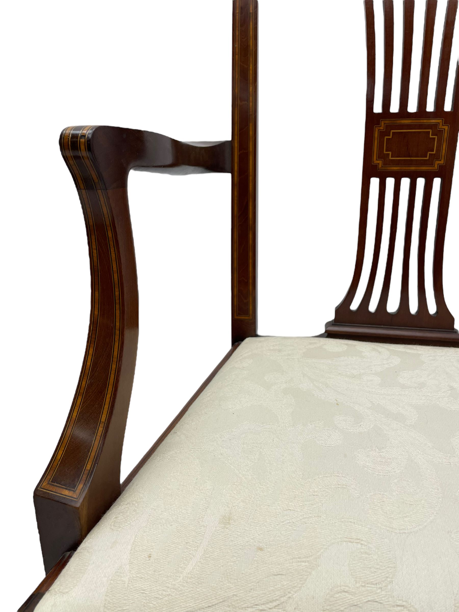 Set twelve (4+8) Edwardian inlaid mahogany dining chairs, cresting rail with satinwood banding, pierced splat backs with central inlay, drop-in seats upholstered in foliate patterned ivory fabric, raised on square tapering supports terminating in spade feet