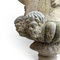 Pair of large cast stone garden urns, circular form with egg and dart border, tapering gadrooned bowl with cast handles and detail