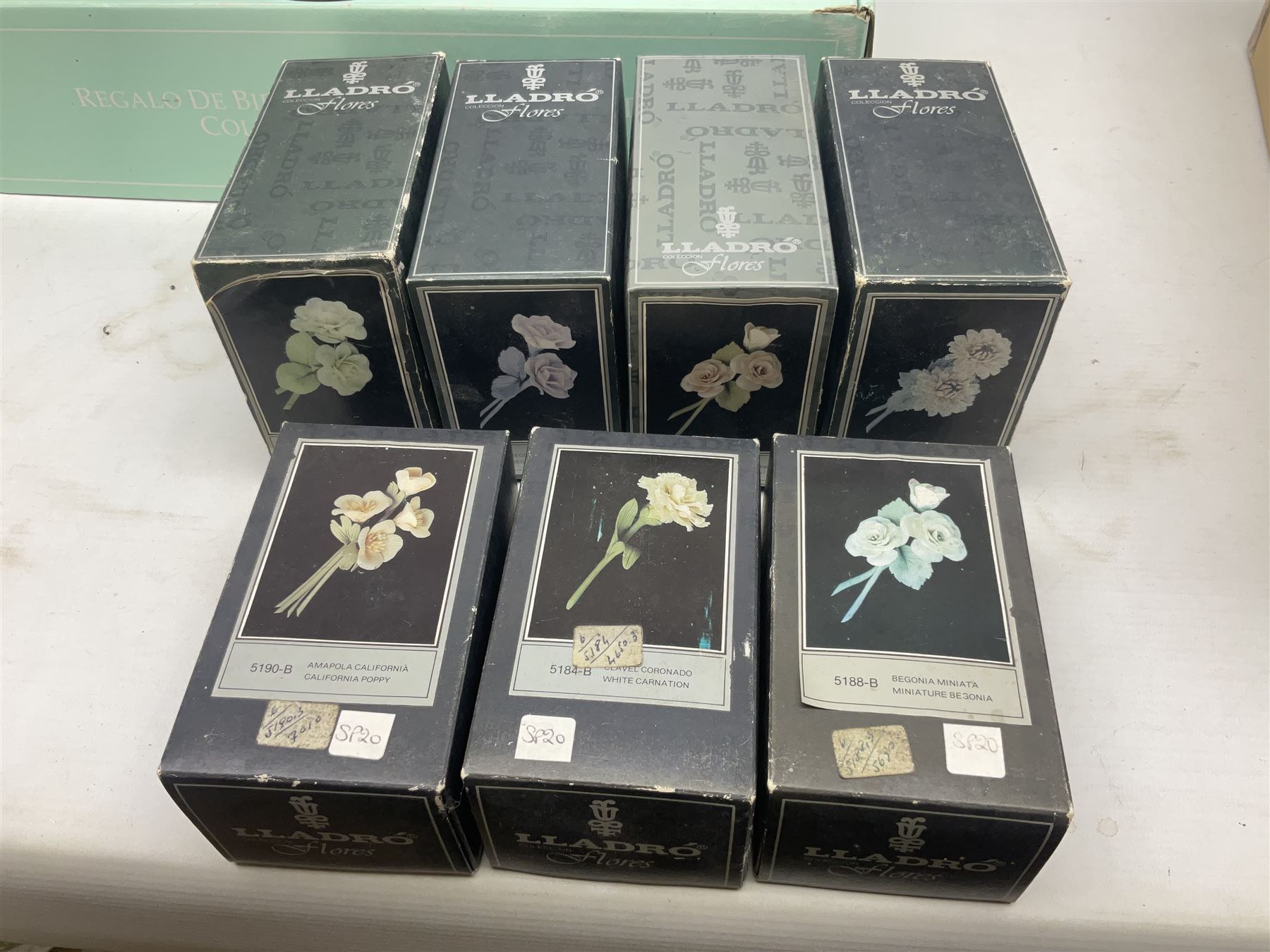 Seven Lladro flowers, comprising Japanese Camelia on base no 5181, Yellow Begonia on base no 5186, Miniature Begonia on base no 5188, Chrysanthemum on base no 5189, California Poppy no 5190.B, Miniature Begonia 5188.B and White Carnation no 5184.B, together with Lladro Spanish Joining pack with 17616 Winter Bell, Additional Lladro parasols and flowers etc 